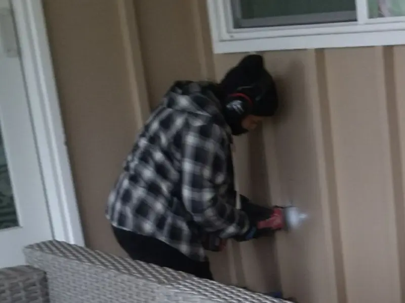 Professional electrician installing an exterior outlet in Wheeling